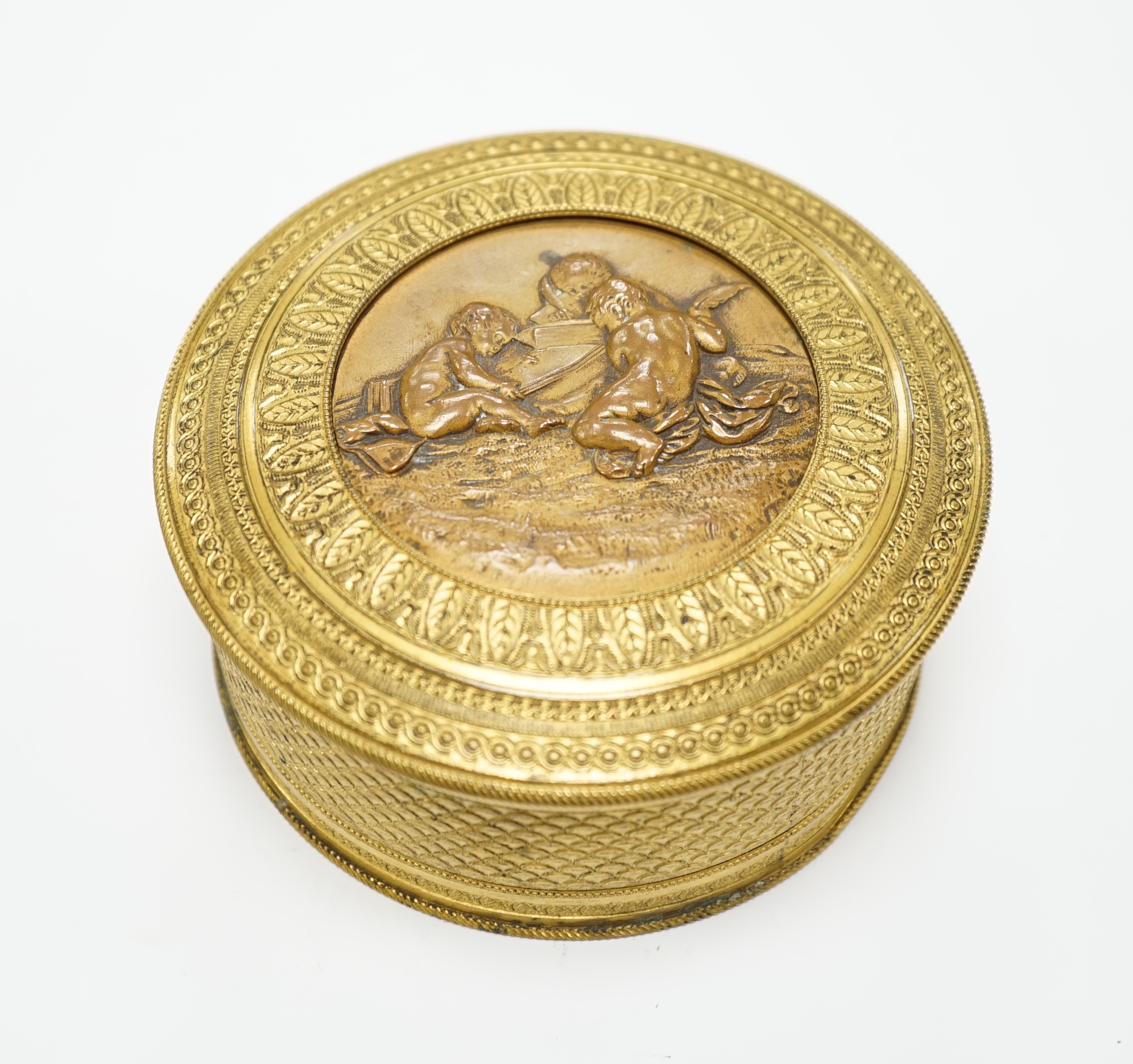 A 19th century French ormolu and bronze cylindrical box and cover with fitted mirror inside lid, 10cm diameter